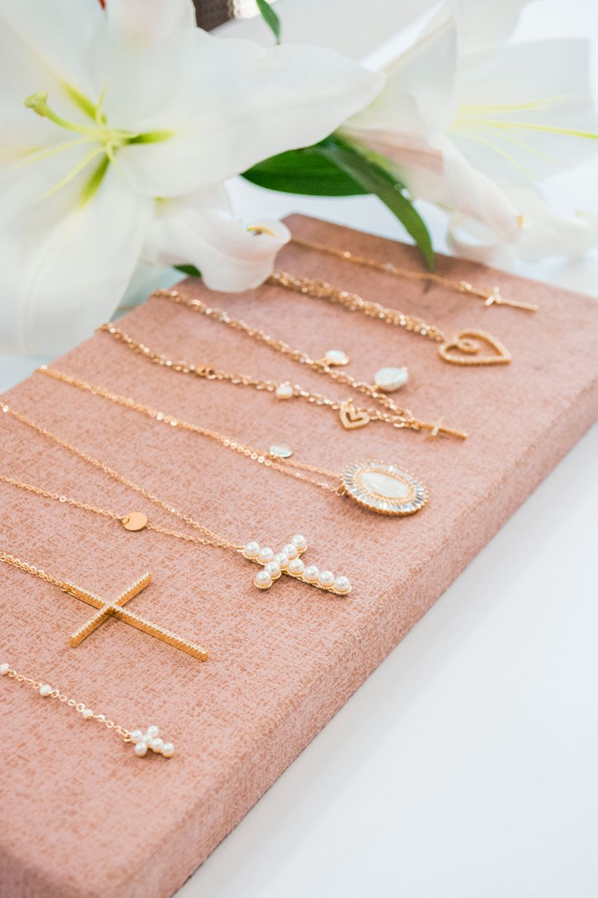 gold cross pendant necklace on brown gift box